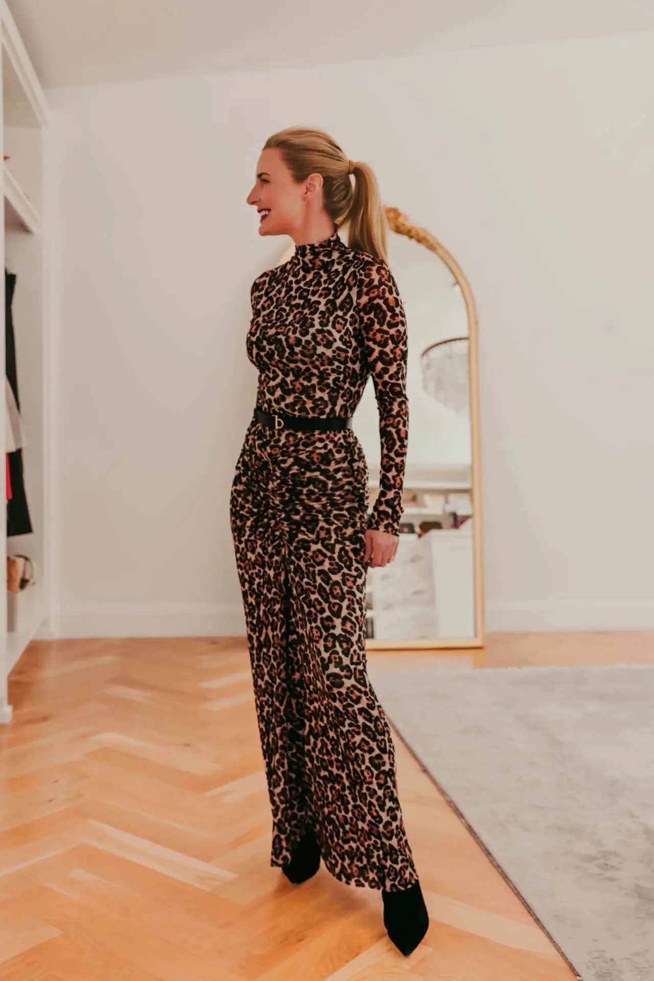 Black-skinny-belt-over-a-leopard-print-fitted-mockneck-maxi-dress-by-Zimmermann-2
