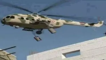 عکس: بالگرد ارتش سوریه در حال رها کردن بشکه انفجاری(برامیل)