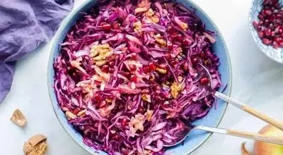 سالاد خوش‌رنگ یلدایی؛ ترکیب انار و کلم قرمز

