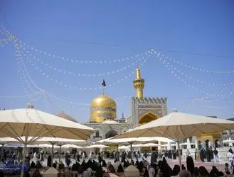 تعویض پرچم گنبد مطهر امام هشتم (ع)/عکس