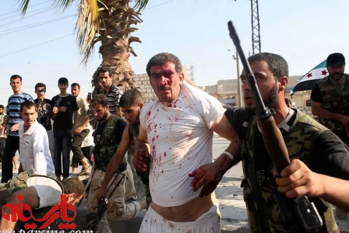 عکس: مخالفان مسلح سوری آماده اعدام یک هوادار بشار الاسد می شوند